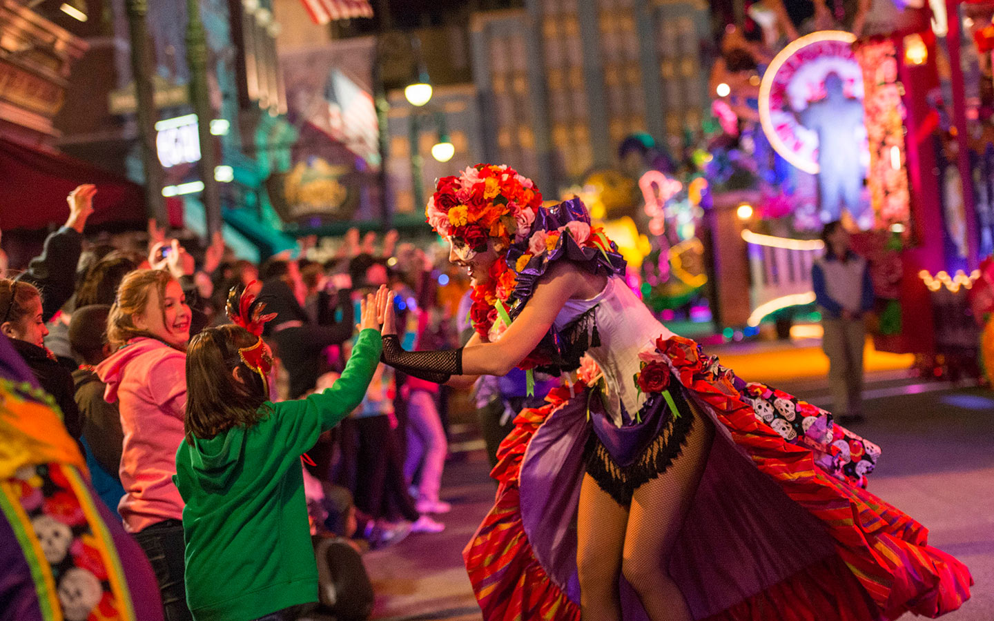 Dance along with masked characters and catch beads during Universal Orlando's Mardi Gras celebration